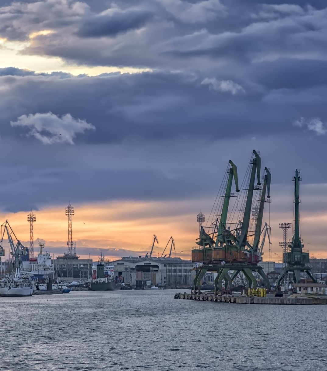 In the evening, the part of port with cranes.Ready to load containers from cargo ships.